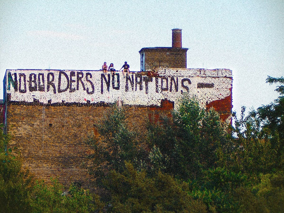 Building with the text 'No borders no nations'